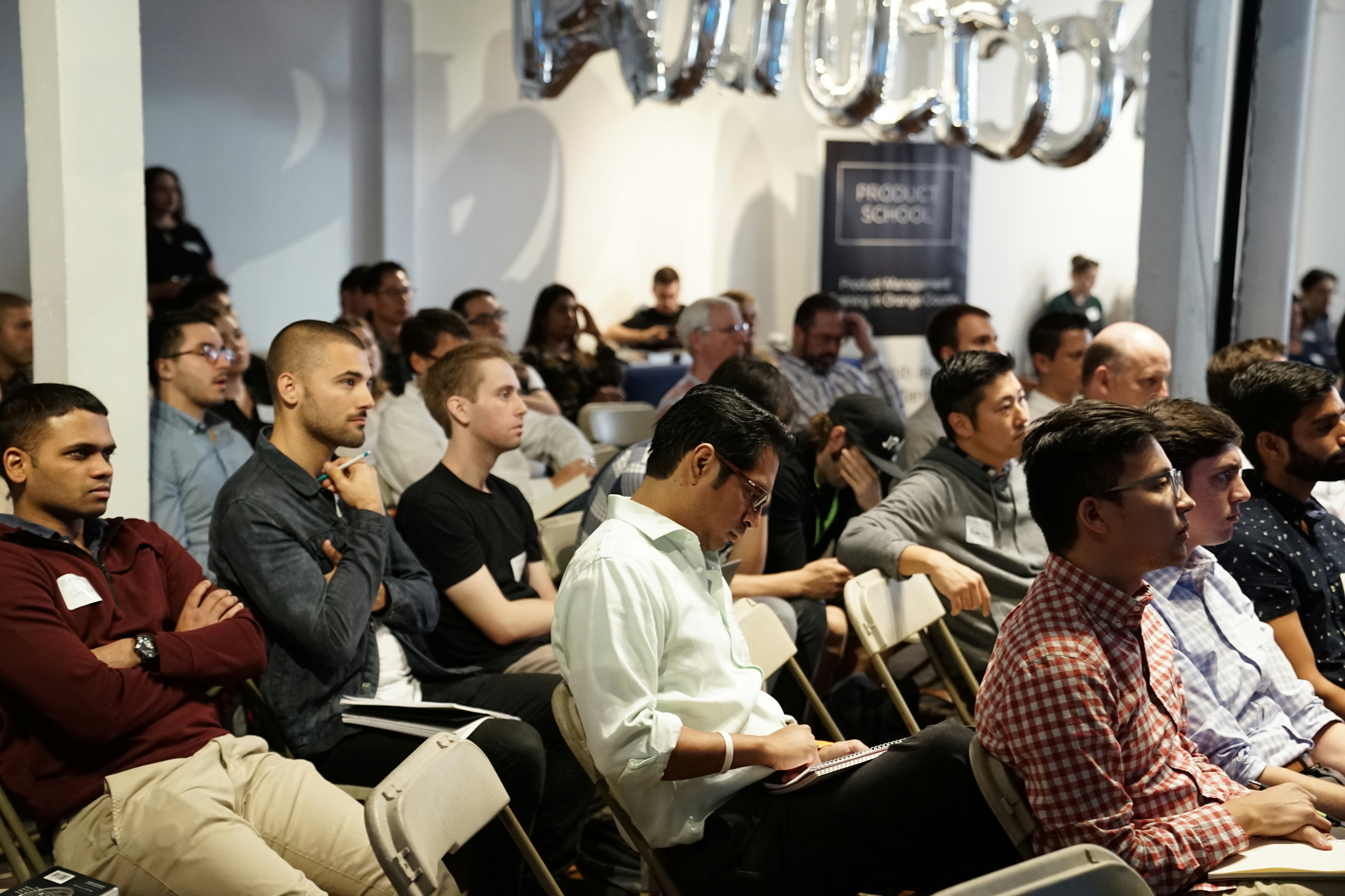 Attendees seated at a presentation